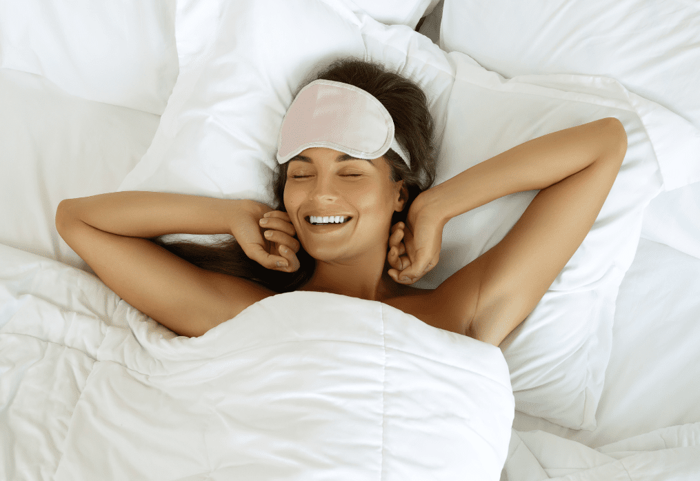 A woman laying in bed with her eyes closed.